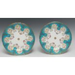 A pair of Minton shaped circular cabinet plates, painted with swags of colourful flowers,