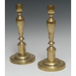 A pair of 19th century French brass table candlesticks, turned knopped stems, domed circular bases,