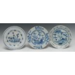 A Delft circular plate, decorated in underglaze blue with stylised flowers,