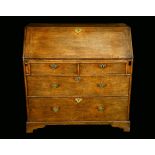 An early George III oak bureau, fall front with reading ledge,