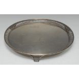 A George V silver circular tray, pierced border, and feet, 31cm diam,