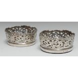 A pair of early Victorian silver circular wine coasters,