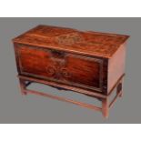 A Scottish vernacular elm six plank chest, hinged top carved with a thistle flanked by scrolls,