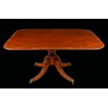 A Regency rosewood crossbanded mahogany rounded rectangular breakfast table, reeded top,