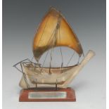 A Middle Eastern silver coloured metal model yacht, 23cm long, 7oz, wooden stand,