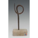 A primitive iron pricket candlestick, wrought in a simple loop, softwood base, 24.