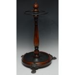 A Victorian mahogany circular stick/umbrella stand, three cast brass lion paw feet, 60cm, c.