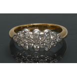 A diamond cluster ring, shaped crest inset with nineteen round brilliant cut diamonds,