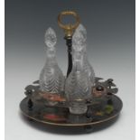 An early 19th century three bottle tole work decanter stand, painted in red,