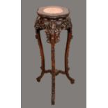 A tall Chinese padouk wood jardiniere stand, shaped circular top with inset soapstone panel,
