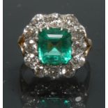 A Columbian emerald and diamond cluster ring, central certified Octagonal cut Columbian emerald,