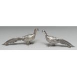 A pair of Continental silver table decorations, as cock and hen pheasants, 27cm and 26cm long,