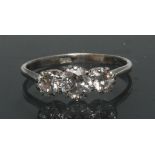 A diamond trilogy ring, central round brilliant cut diamond approx 0.