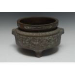 A large Chinese bronze ding censer, cast in relief with bands of lotus, flowerheads and dragons,