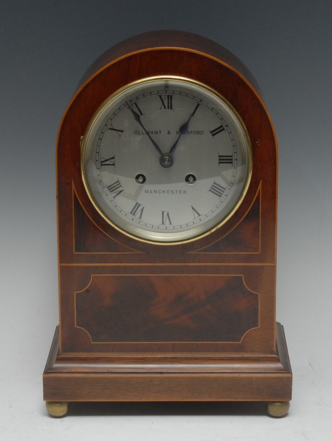 An English George V mahogany and box inlaid mantel clock, arched top,