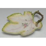 A Chelsea leaf shaped dish, painted with flowers and sprigs, veins in puce, branch loop handle,