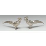 A pair of Continental silver novelty canisters, as exotic birds, each head detachable as a cover,