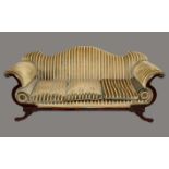 A Regency Revival mahogany scroll end sofa, shaped back, stuffed over Empire stripe upholstery,