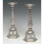 A pair of Indian silver candlesticks, broad circular sconces, lotus baluster pillars,