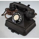 A mid 20th century black Bakelite telephone,