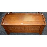 An oak blanket chest, hinged top above a nulled front,