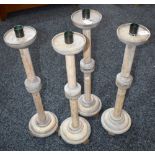 A set of four large ash ecclesiastical candlesticks,