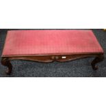A Victorian mahogany footstool, drop-in cushion, shaped scrolling serpentine frieze,