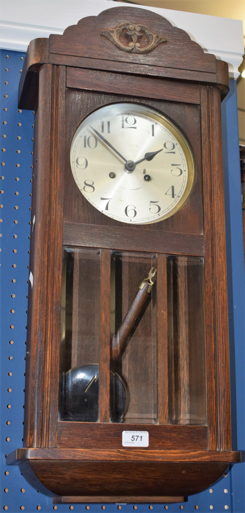 An early 20th century oak cased wall clock, silvered dial, Arabic numerals,