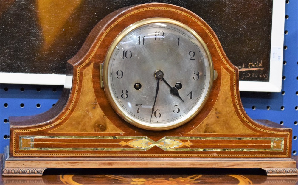 A mahogany mantel clock, silvered dial, Arabic numerals, twin winding holes,