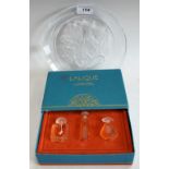 A set of three Lalique Glass Ultimate Collection miniature scent bottles, boxed; a Hoya glass plate,