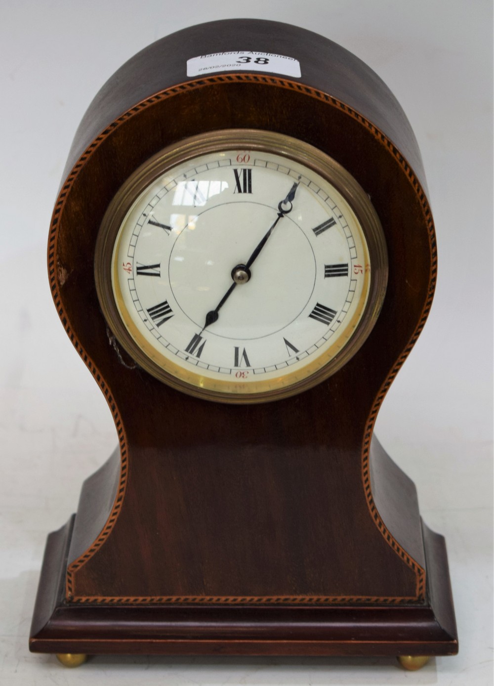 An Edwardian inlaid mahogany balloon time piece, cream dial, Roman numerals, brass ball feet,