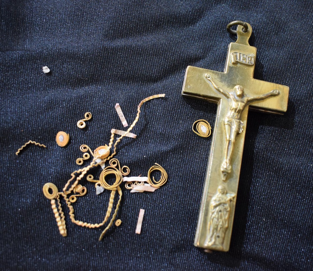 A brass reliquary cross pendant, the front relief cast with Christ above a Saint,