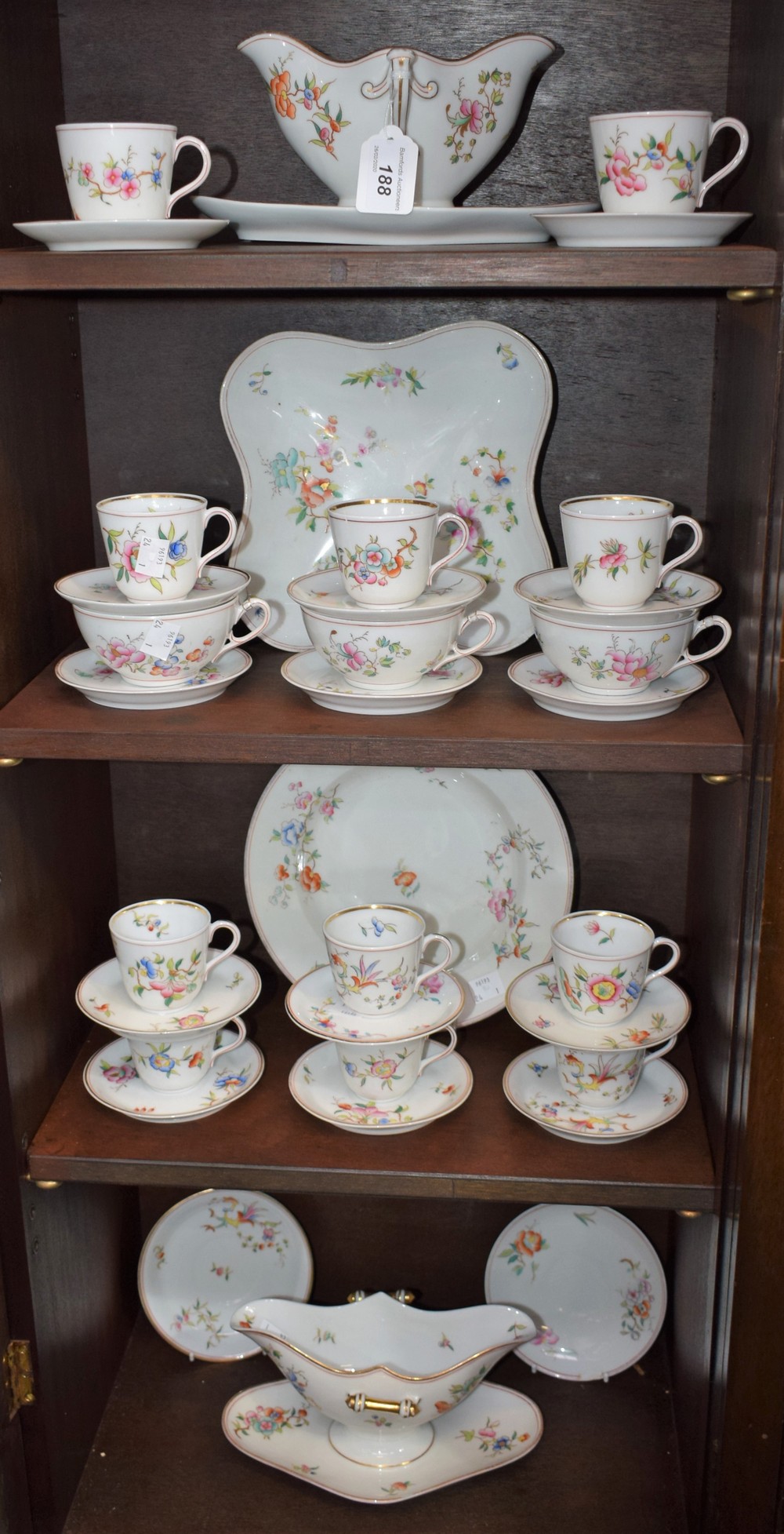 A late 19th century porcelain part service, floral sprigs on white ground, including sauce boats,