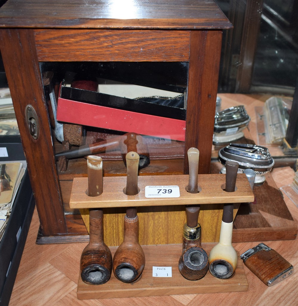 An oak smokers cabinet, glazed door; assorted pipes, including Barling with silver mount,