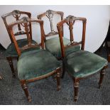 A set of four Victorian Aesthetic Movement carved back dining chairs, upholstered seats,