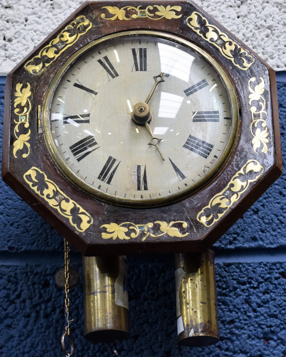 A rosewood octagonal brass and abalone shell inlaid wall clock, white painted dial, Roman numerals,