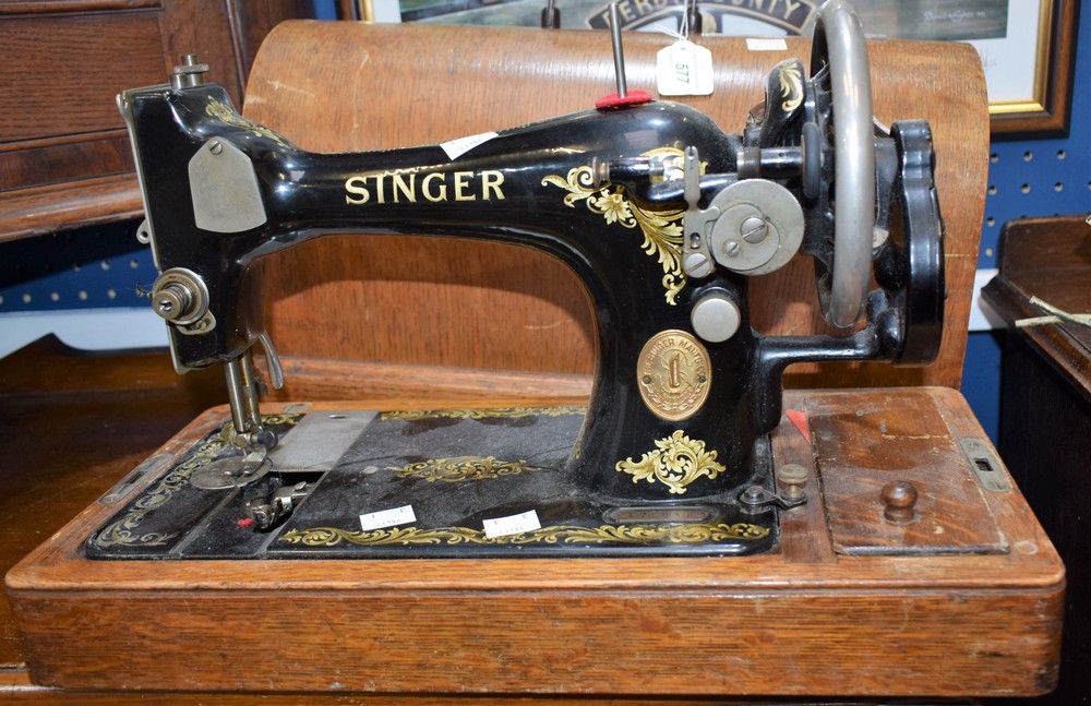 A late 19th early 20th century Singer hand cranked sewing machine, serial no Y172415,