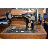 A late 19th early 20th century Singer hand cranked sewing machine, serial no Y172415,