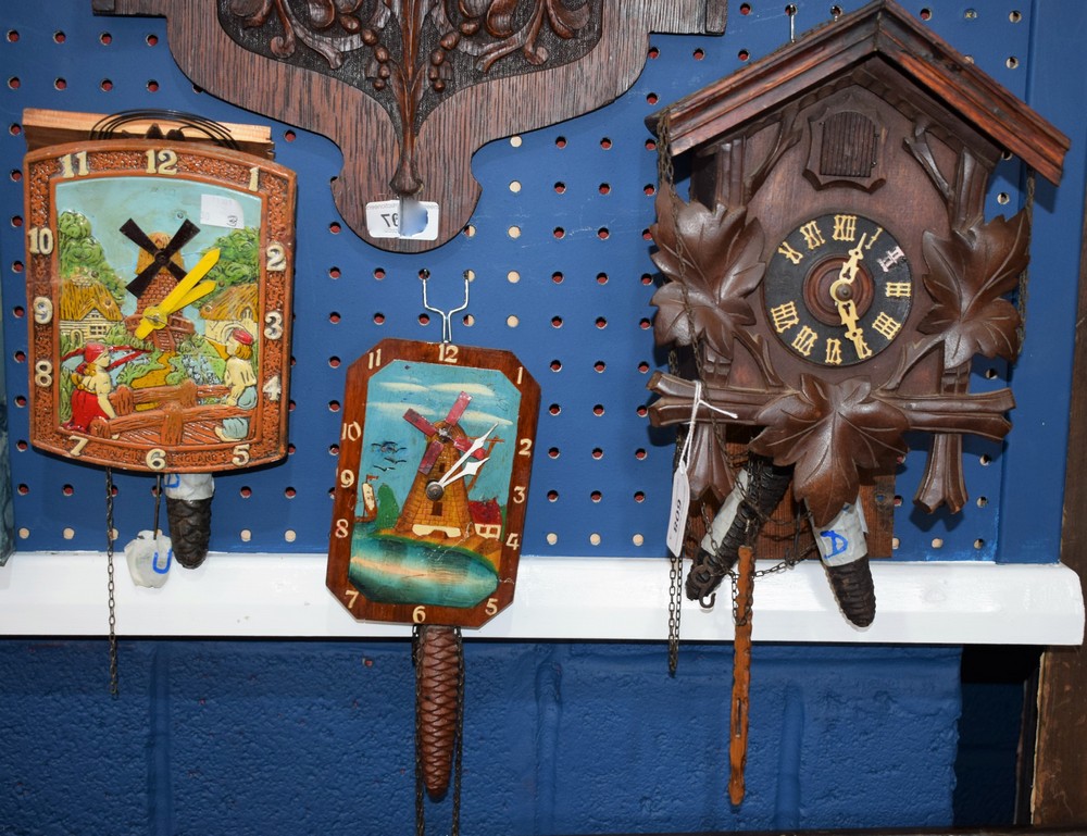 A Black Forest Cuckoo clock; a tin Dutch scene wall clock, with landscape,