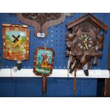 A Black Forest Cuckoo clock; a tin Dutch scene wall clock, with landscape,