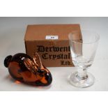 A Wedgwood amber glass paperweight, as a rabbit; a Dartington lead crystal commemorative goblet,