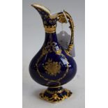 A Royal Crown Derby ewer, applied in raised gilt with floral swags on a cobalt blue ground,