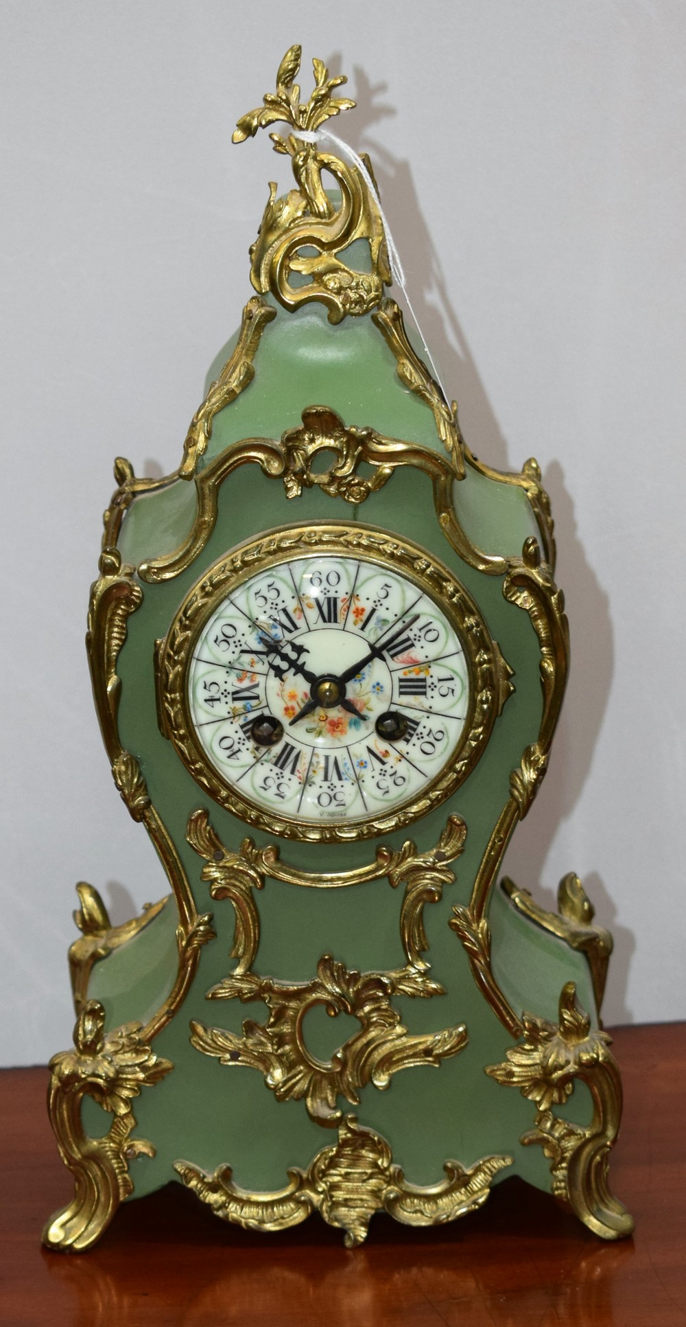 A Louis XV style mantel clock, painted enamel dial, Roman numerals, twin winding holes,