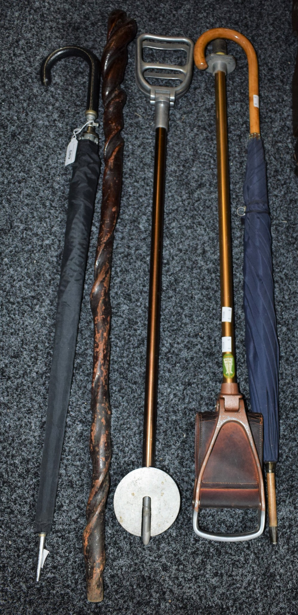 A shooting stick; another; umbrellas;