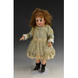 A bisque head doll, with open blue eyes, painted lashes and brows, closed mouth, pierced ears,