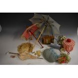 A quantity of Victorian and later dolls' accessories to include parasols, silk and other bonnets,