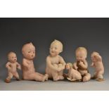 A Gebruder Heubach bisque Kewpie piano baby, moulded features, intaglio eyes, seated naked, 9743,