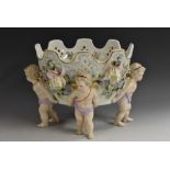 A German figural centrepiece, with four cherubs supporting a pierced basket,