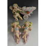 A German figural centrepiece, the shell chariot being pulled by two cherubs, in pastel tones,