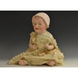 A Gebruder Heubach bisque head baby doll, with blue eyes, slightly open mouth,